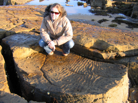 Lucinda Shepherd and prehistoric ripple marks preserved in the exposed rock
