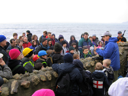Chris Pamplin provides an introduction to participants on a Discovering Fossils fossil hunt at Lyme Regis