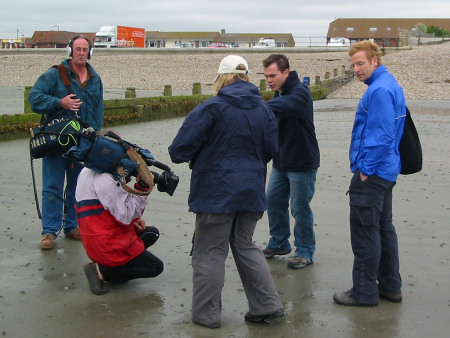 Roy Shepherd describes the fossils of Bracklesham Bay to Paul Hendy and the film crew